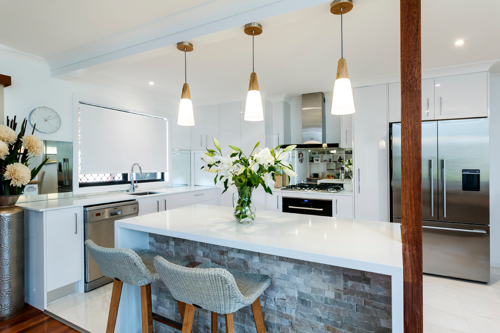 Design ideas for a small contemporary l-shaped kitchen in Gold Coast - Tweed with an undermount sink, flat-panel cabinets, white cabinets, quartz benchtops, mirror splashback, stainless steel appliances, porcelain floors and with island.