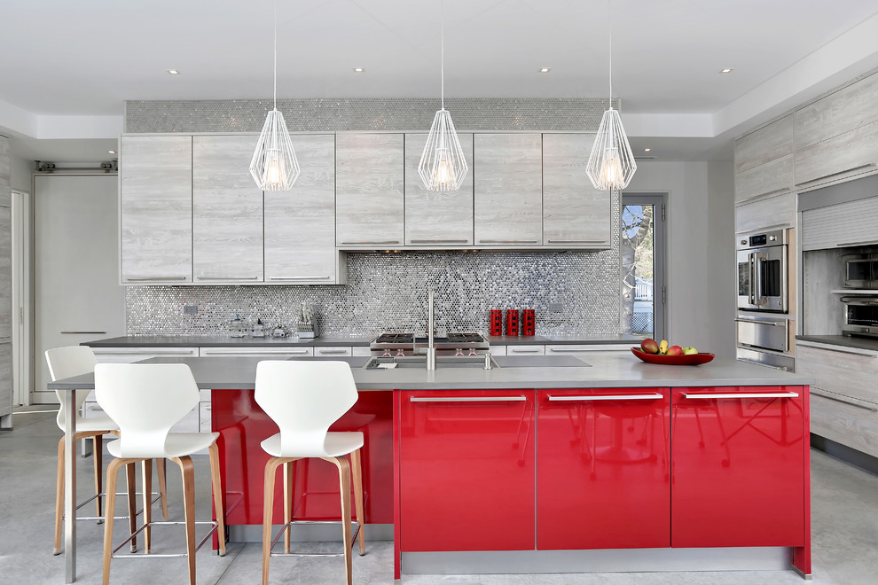 Inspiration for a mid-sized contemporary l-shaped kitchen in Other with flat-panel cabinets, red cabinets, quartzite benchtops, grey splashback, mosaic tile splashback, stainless steel appliances, concrete floors, with island, grey floor and an undermount sink.