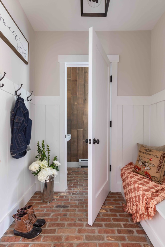 Inspiration for a country entryway in Burlington with multi-coloured walls, brick floors and red floor.