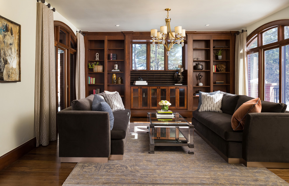 Mid-sized transitional living room in Denver with a library, beige walls, medium hardwood floors and no fireplace.