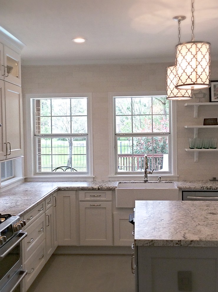 Mid-sized transitional u-shaped ceramic tile eat-in kitchen photo in Houston with a farmhouse sink, recessed-panel cabinets, white cabinets, granite countertops, white backsplash, stone tile backsplash, stainless steel appliances and an island