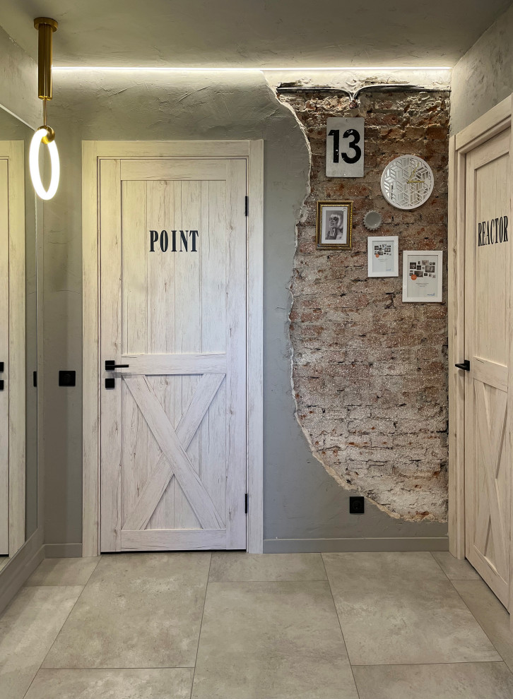 Inspiration for a small industrial entryway in Yekaterinburg with blue walls, porcelain floors, a single front door, a gray front door, grey floor and brick walls.