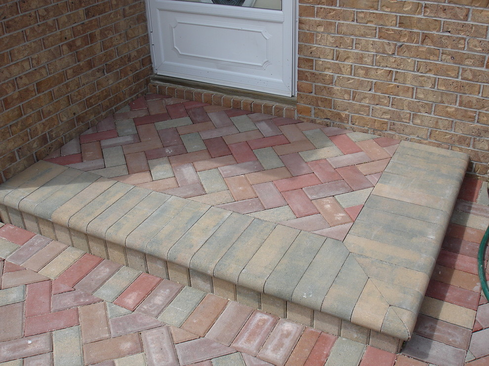 Inspiration for a small traditional backyard patio in Other with concrete pavers.