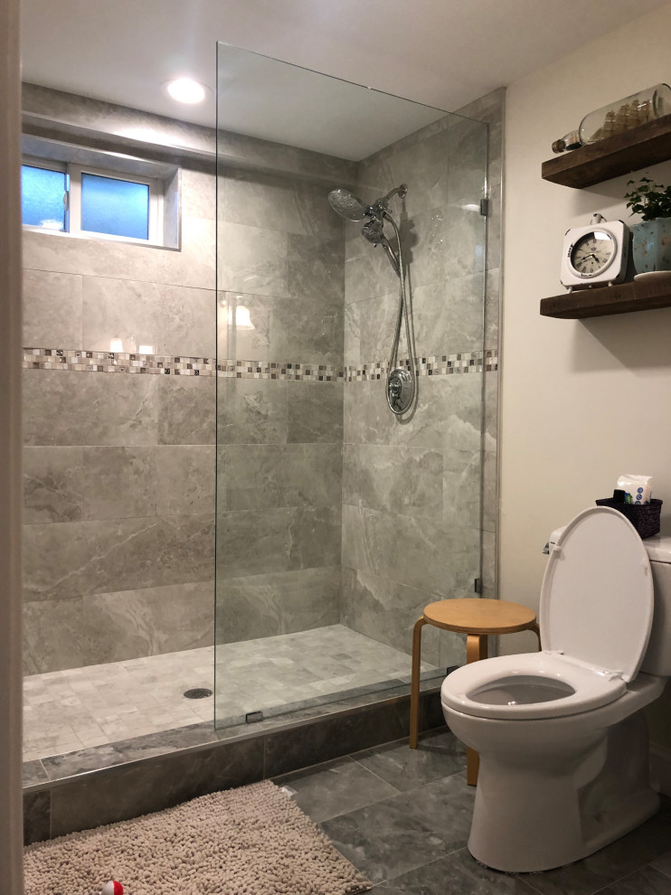 Inspiration for a large modern bathroom in Boston with laminate floors, grey floor, a one-piece toilet, an integrated sink, a hinged shower door and a niche.