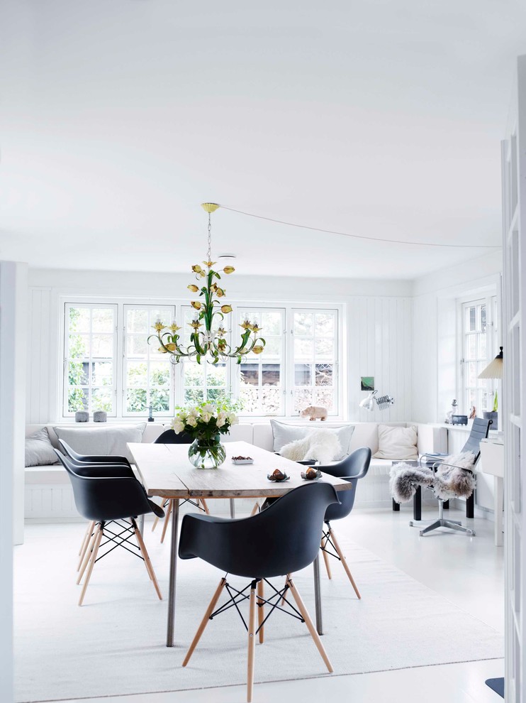 Design ideas for a mid-sized scandinavian separate dining room in Odense with white walls and painted wood floors.
