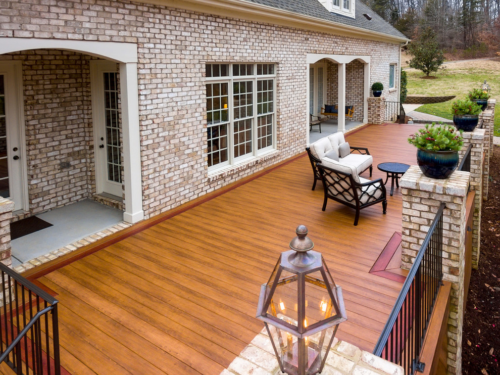 Inspiration for a large transitional backyard deck remodel with a fire pit and no cover