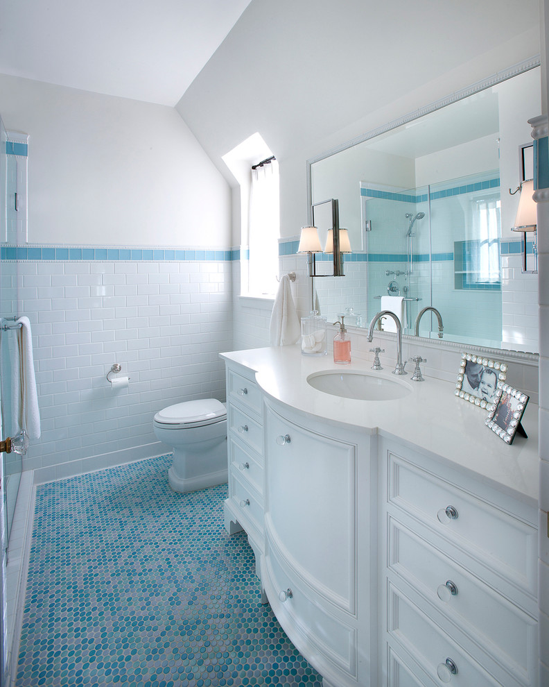 This is an example of a traditional bathroom in Phoenix with an undermount sink, white cabinets, white tile, subway tile, white walls, mosaic tile floors and recessed-panel cabinets.