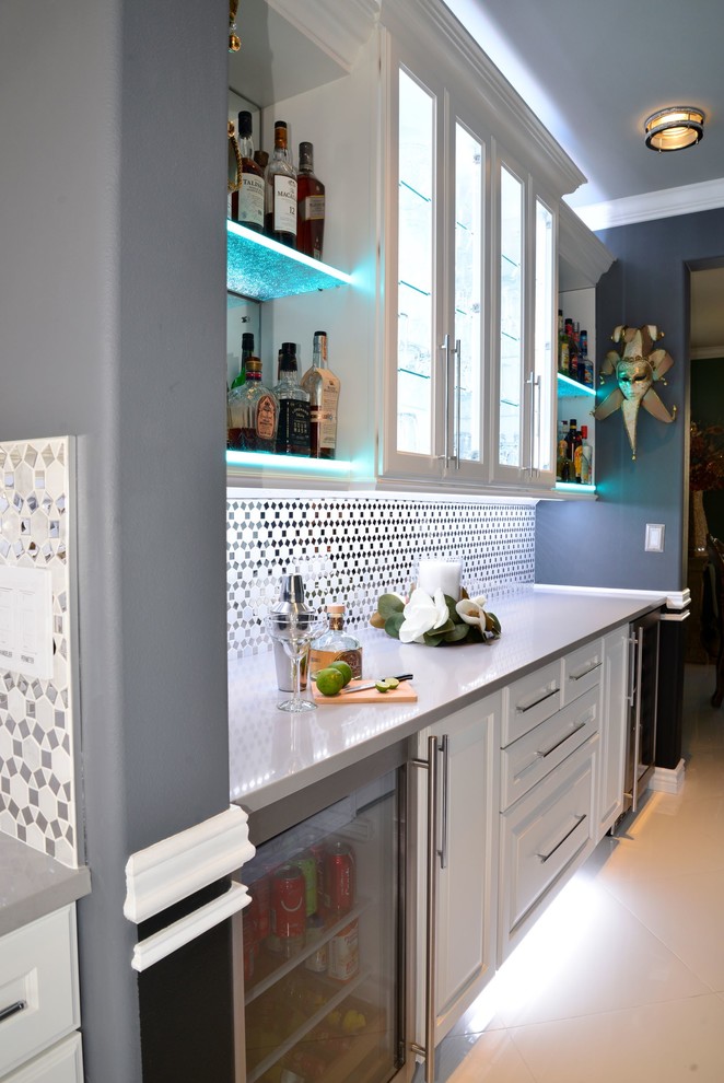 Inspiration for a mid-sized traditional single-wall wet bar in Seattle with raised-panel cabinets, white cabinets, multi-coloured splashback, mirror splashback, porcelain floors, white floor and white benchtop.