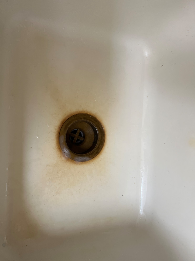 How do I clean the yellow stain on the kitchen sink? It is a corrian a