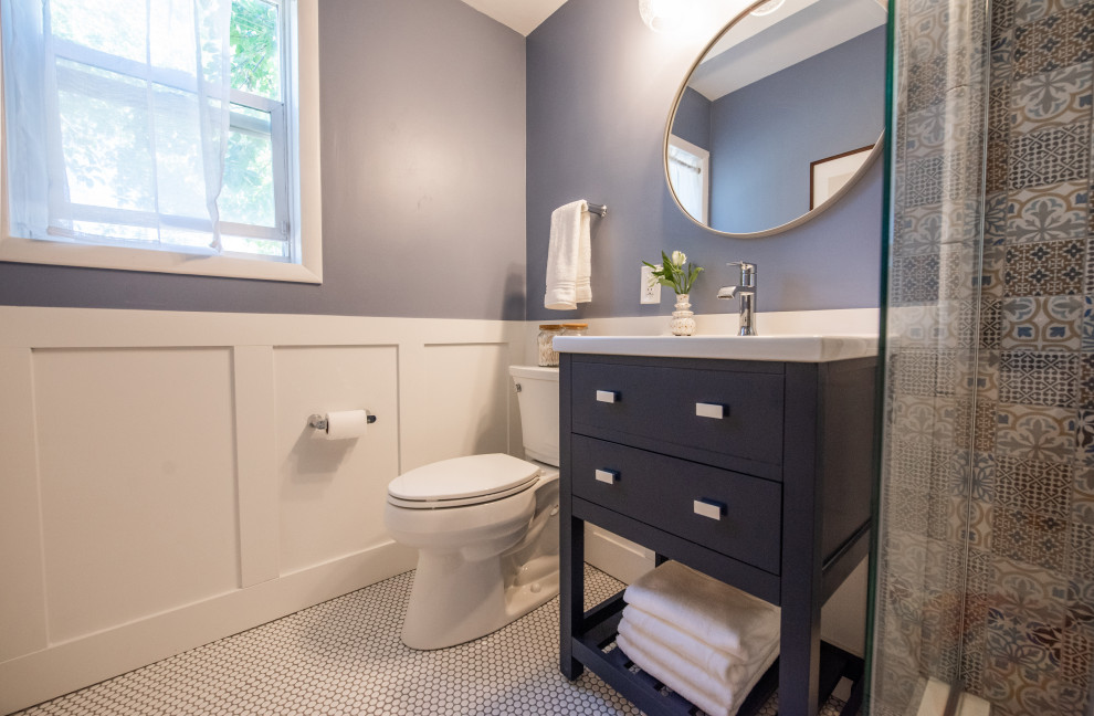 Small transitional powder room in Denver with open cabinets, blue cabinets, a two-piece toilet, ceramic tile, blue walls, ceramic floors, an integrated sink, white floor, white benchtops, a freestanding vanity and decorative wall panelling.
