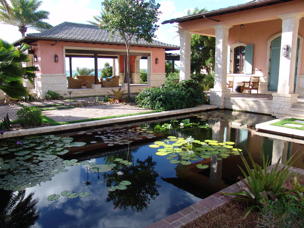 Photo of a tropical garden in Miami with a water feature.