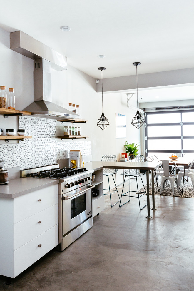 Design ideas for a mid-sized contemporary galley eat-in kitchen in San Francisco with an undermount sink, flat-panel cabinets, white cabinets, quartz benchtops, white splashback, ceramic splashback, stainless steel appliances, concrete floors and no island.