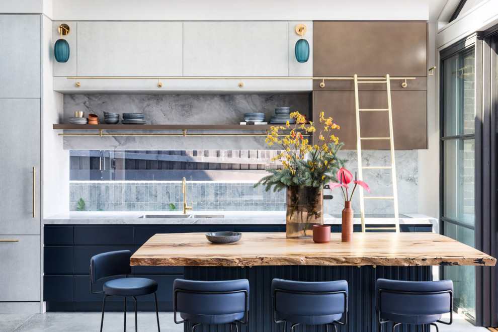 Industrial kitchen in Sydney with marble benchtops, grey splashback, marble splashback, concrete floors, with island, grey floor and multi-coloured benchtop.