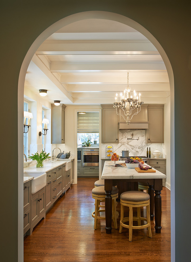 Design ideas for a traditional u-shaped separate kitchen in DC Metro with a farmhouse sink, recessed-panel cabinets, blue cabinets, marble benchtops, panelled appliances, dark hardwood floors and with island.