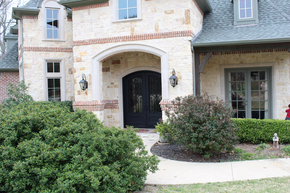 Photo of a traditional front door in Dallas with a double front door and a metal front door.