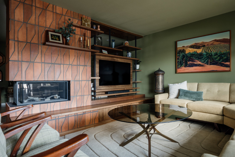 1950s medium tone wood floor living room photo in Denver with green walls, a two-sided fireplace and a tile fireplace
