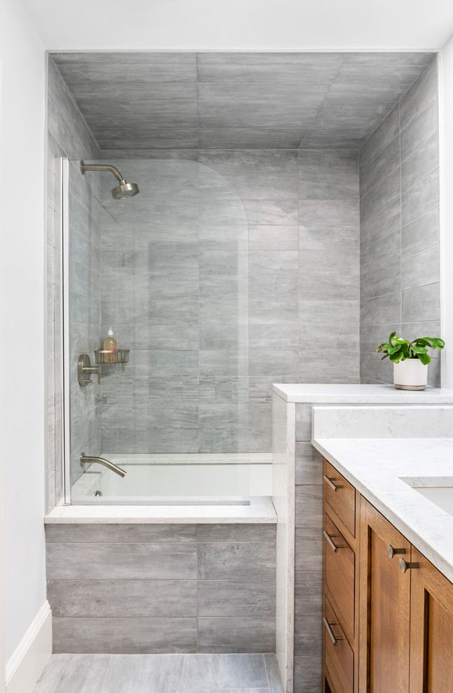 Design ideas for a small transitional bathroom in Boston with shaker cabinets, dark wood cabinets, beige tile, porcelain tile, porcelain floors, an undermount sink, engineered quartz benchtops, white floor, a hinged shower door and white benchtops.