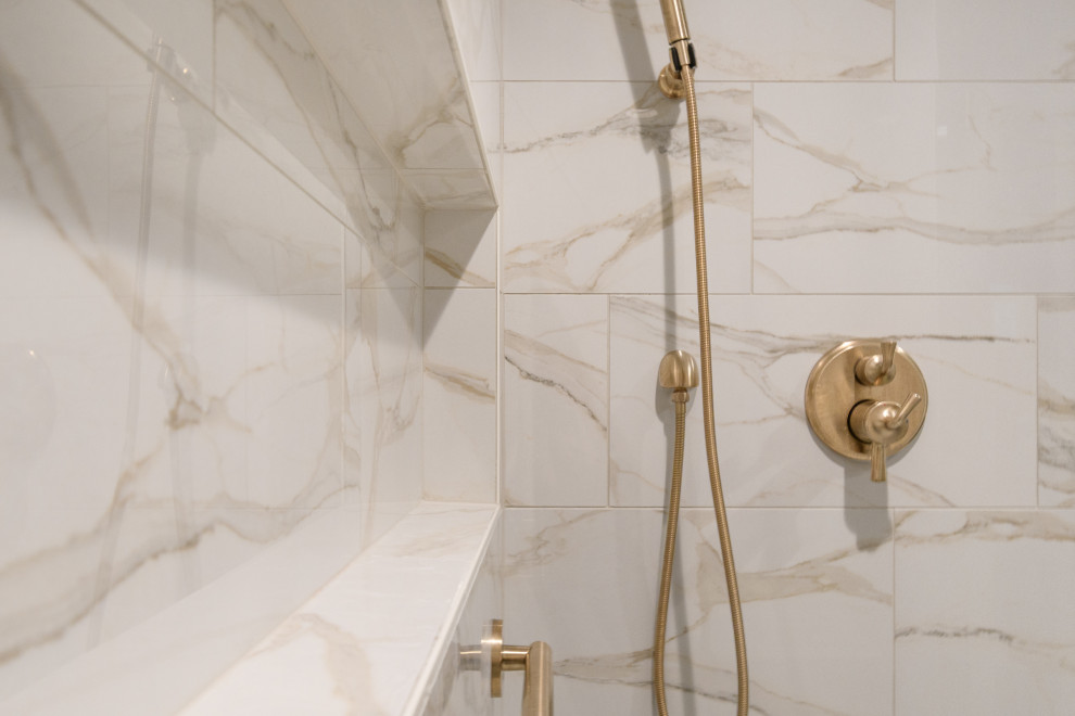 Example of a transitional white tile and porcelain tile alcove shower design in Minneapolis with beige walls and a hinged shower door