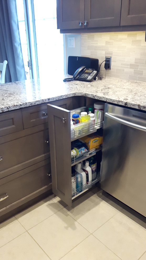 Mid-sized transitional u-shaped porcelain tile eat-in kitchen photo in Toronto with shaker cabinets, gray cabinets, granite countertops, a peninsula, an undermount sink, gray backsplash and stainless steel appliances