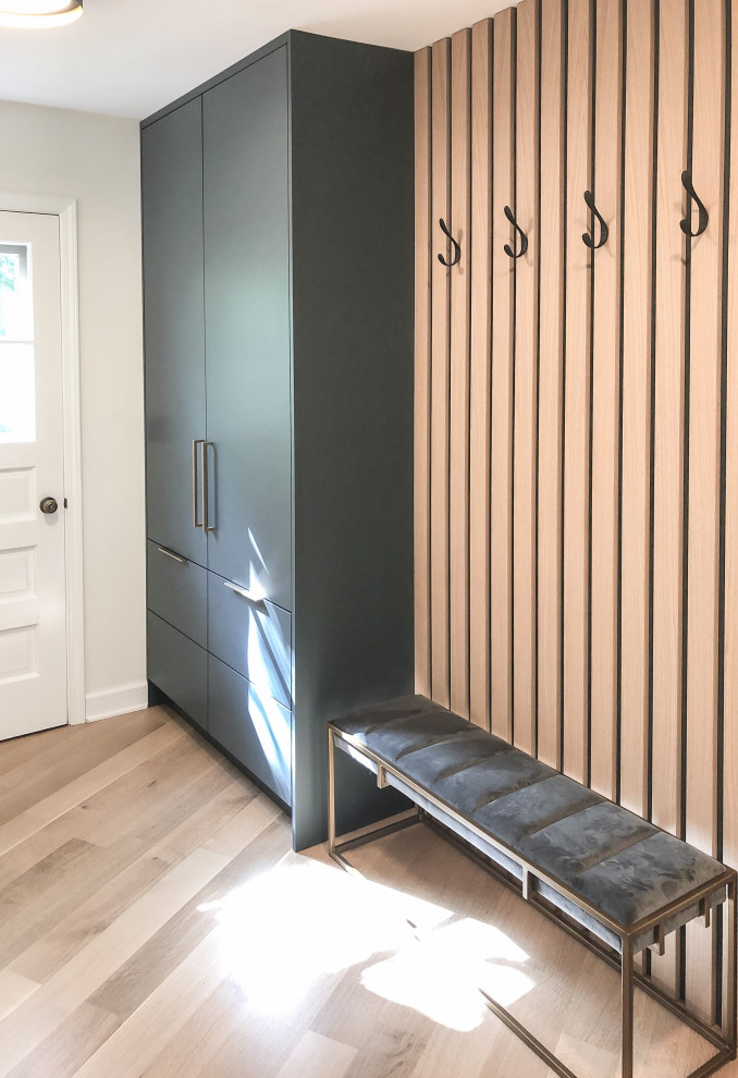 Photo of a small contemporary mudroom in Chicago with white walls, light hardwood floors, a single front door, a white front door and beige floor.