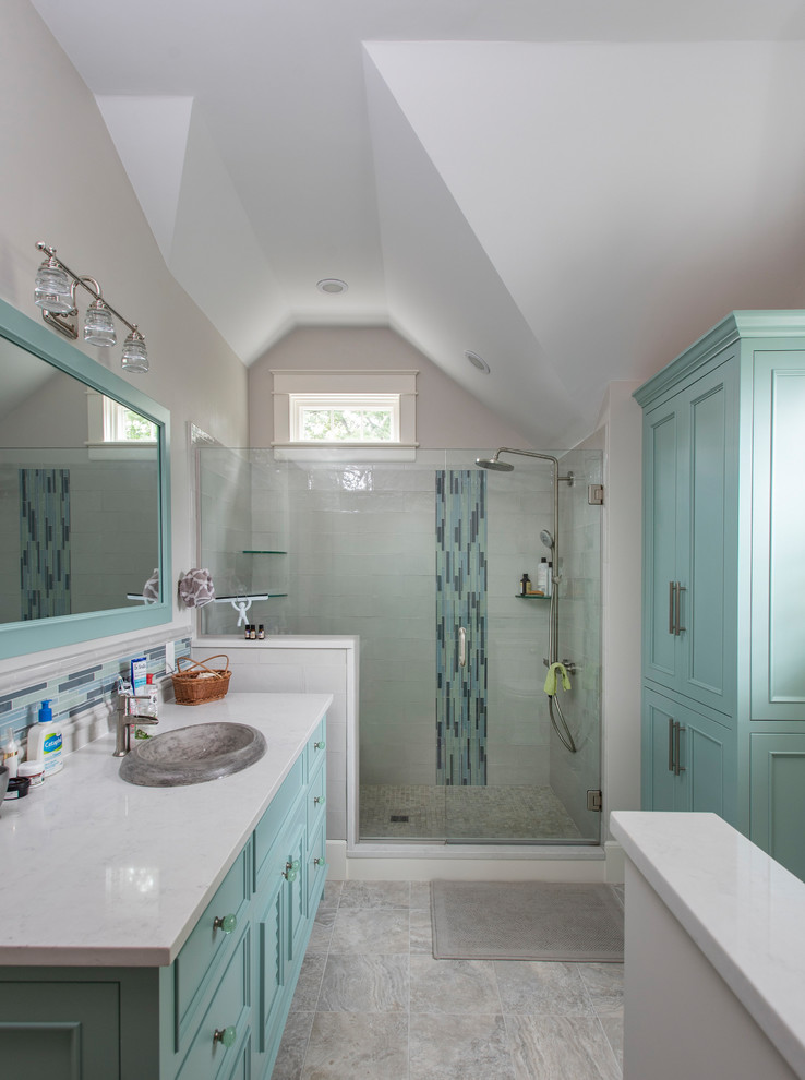 Inspiration for a small beach style kids bathroom in Boston with furniture-like cabinets, brown cabinets, a drop-in tub, a corner shower, a one-piece toilet, blue walls, porcelain floors, a drop-in sink, marble benchtops, multi-coloured floor, a hinged shower door and beige benchtops.