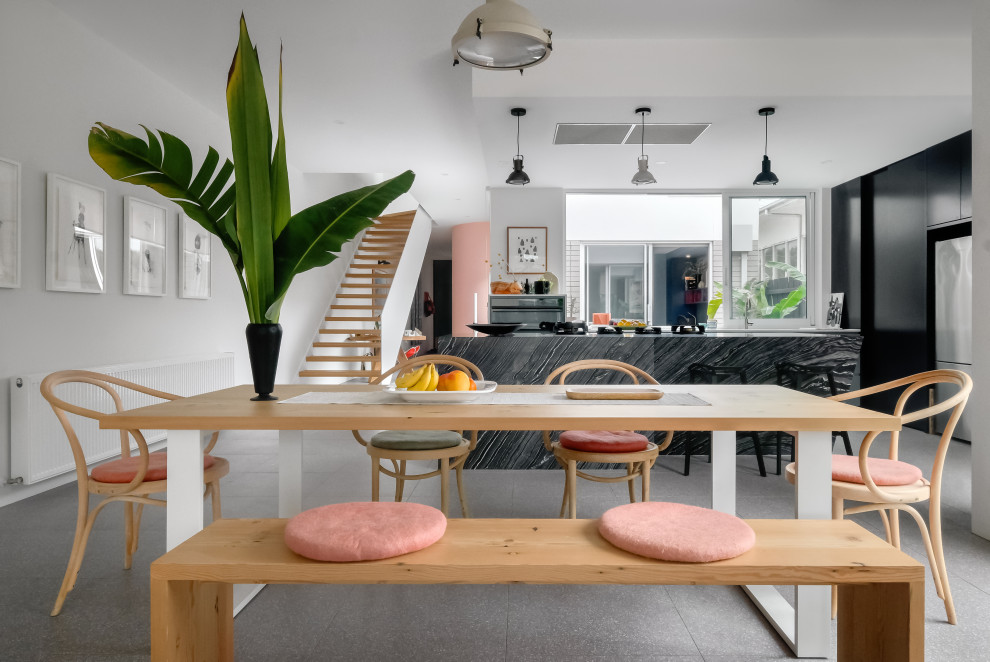 Inspiration for a mid-sized contemporary dining room in Melbourne with white walls, porcelain floors and grey floor.