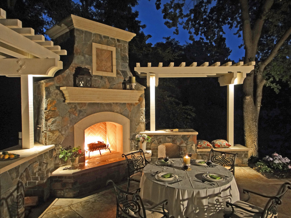 Photo of a mid-sized traditional backyard patio in San Francisco with stamped concrete, a pergola and with fireplace.