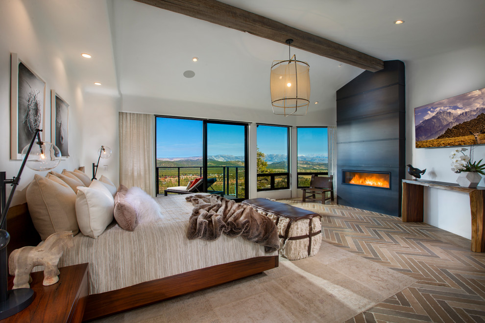 Photo of a country master bedroom in Orange County with white walls, a ribbon fireplace, a metal fireplace surround, multi-coloured floor and vaulted.