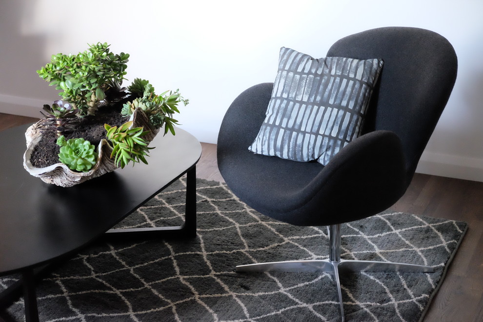 This is an example of a small contemporary enclosed living room in Sydney with grey walls and dark hardwood floors.