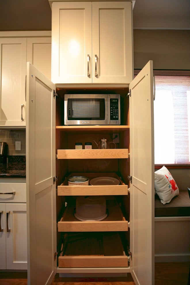 Mid-sized transitional galley medium tone wood floor and beige floor eat-in kitchen photo with shaker cabinets, white cabinets, granite countertops, green backsplash, subway tile backsplash, stainless steel appliances and no island
