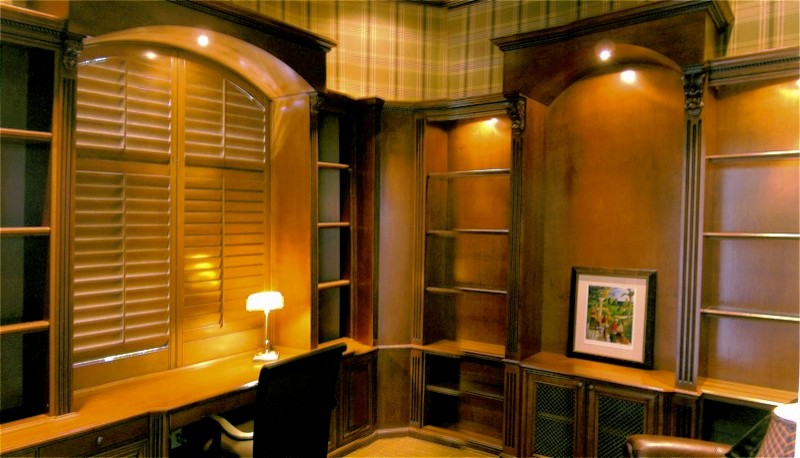 Photo of a large traditional home office in Miami with a library, beige walls, carpet, a built-in desk and multi-coloured floor.