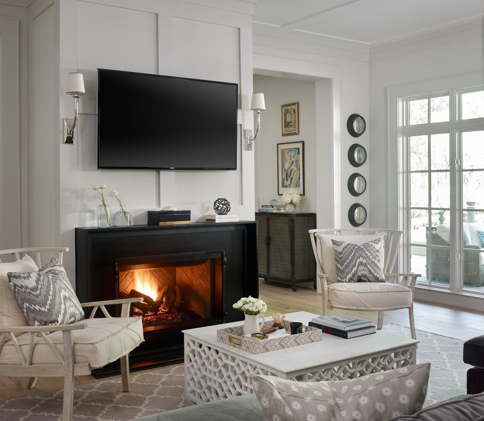 Transitional living room in Atlanta with a metal fireplace surround.