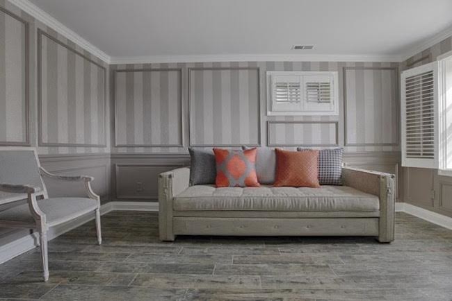 Photo of a mid-sized transitional enclosed family room in New York with grey walls and light hardwood floors.