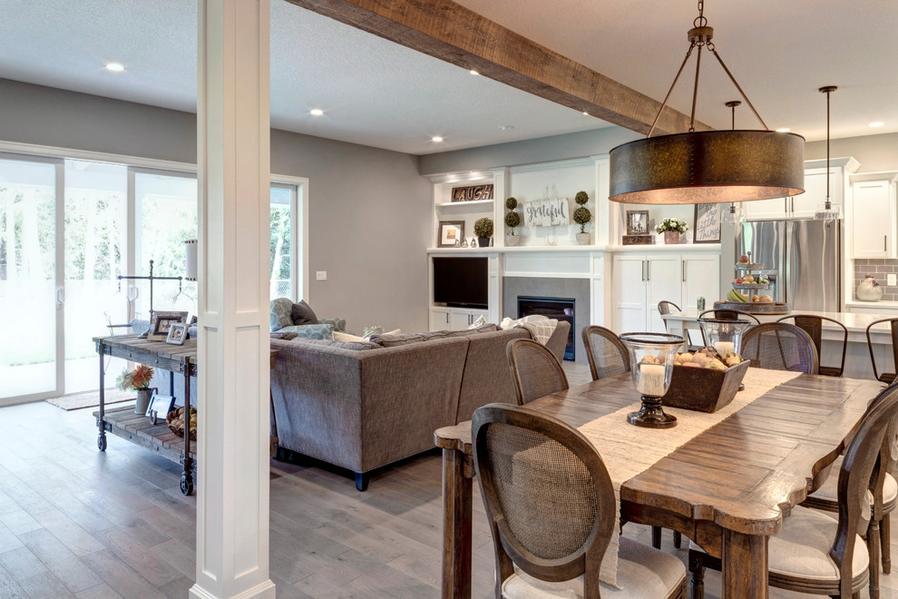 This is an example of a large country open plan dining in Portland with brown floor.