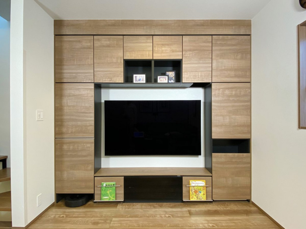 This is an example of a mid-sized contemporary formal open concept living room in Tokyo Suburbs with white walls, medium hardwood floors, a wall-mounted tv, brown floor, wallpaper and wallpaper.