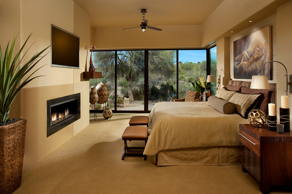 Master bedroom in Phoenix with beige walls, carpet and a ribbon fireplace.