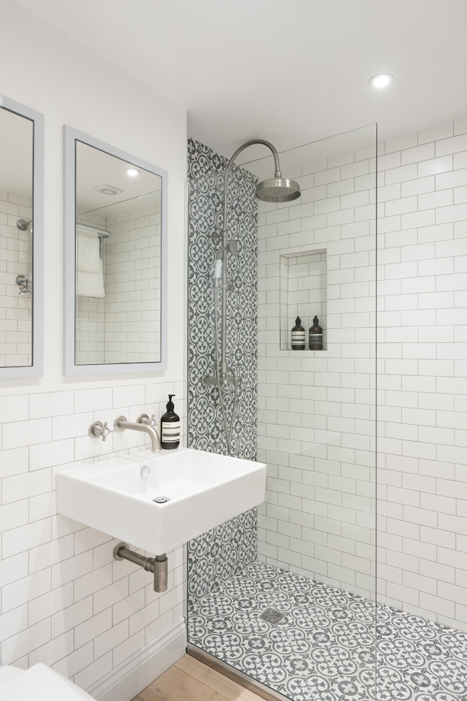 Inspiration for a small contemporary 3/4 bathroom in London with an open shower, white tile, white walls, cement tiles, a wall-mount sink, a hinged shower door, subway tile and beige floor.