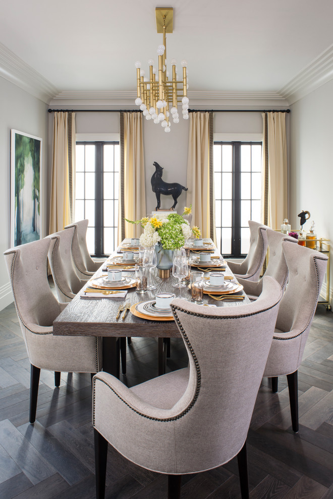 Large transitional open plan dining in Los Angeles with white walls, medium hardwood floors and brown floor.