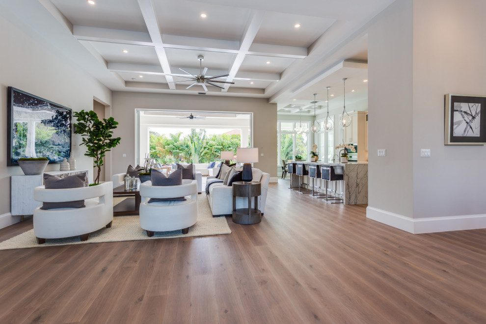 Inspiration for a large beach style open plan living room in Other with beige walls, medium hardwood flooring, a wall mounted tv and a coffered ceiling.