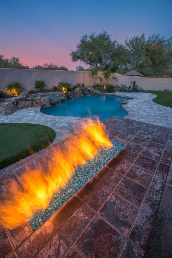 Inspiration for a mid-sized coastal backyard tile and custom-shaped pool fountain remodel in Phoenix