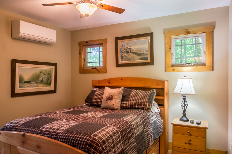 Mid-sized country master bedroom in Other with beige walls.