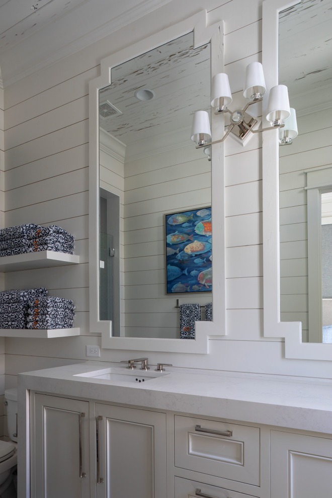 This is an example of a large nautical shower room bathroom in Other with recessed-panel cabinets, white cabinets, an alcove bath, a one-piece toilet, white walls, ceramic flooring, a built-in sink, beige floors, a hinged door, white worktops, double sinks, a floating vanity unit, a wood ceiling and tongue and groove walls.