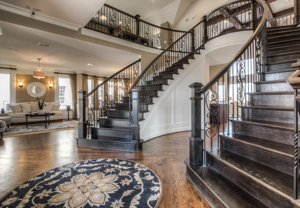 Inspiration for a large traditional wood curved staircase in San Diego with wood risers and mixed railing.