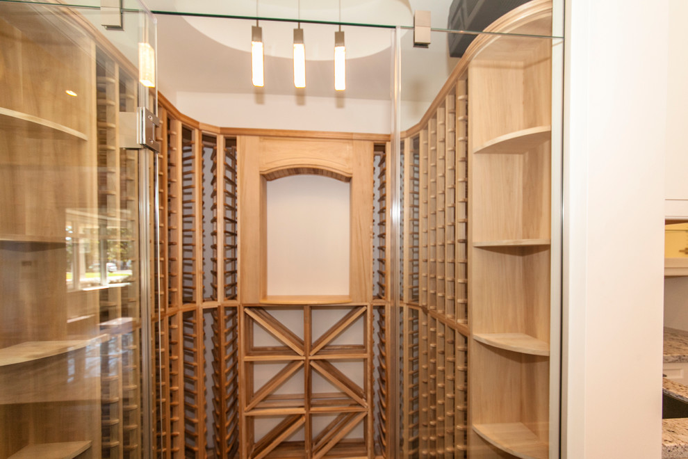 Mid-sized transitional dark wood floor wine cellar photo in Toronto with storage racks