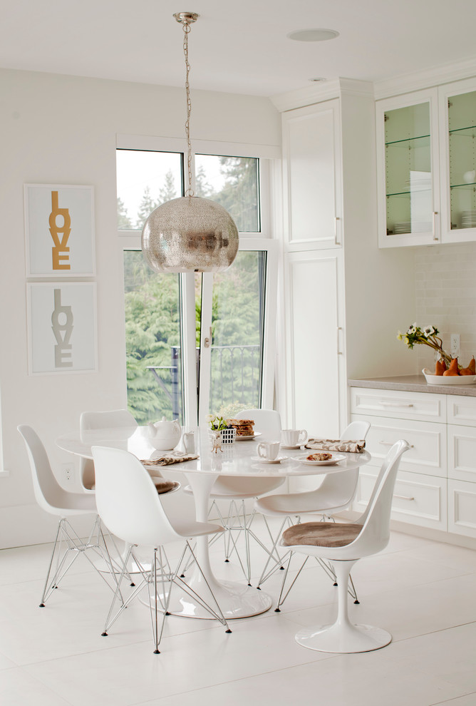 This is an example of a contemporary dining room in Vancouver with white walls, painted wood floors and white floor.