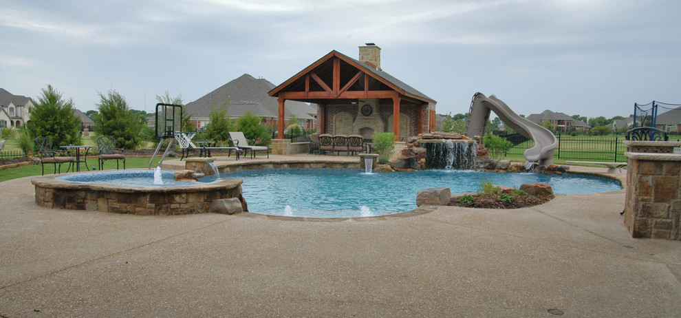 Inspiration for a large backyard custom-shaped natural pool in Dallas with a hot tub and concrete pavers.
