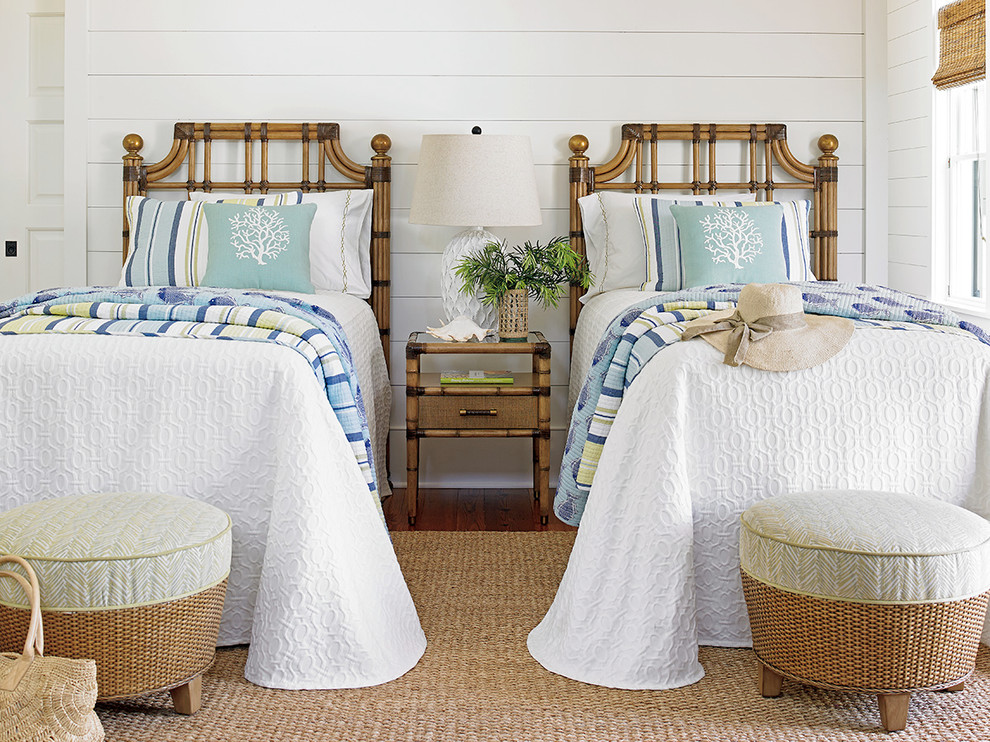 Design ideas for a small tropical guest bedroom in Charleston with white walls and medium hardwood floors.