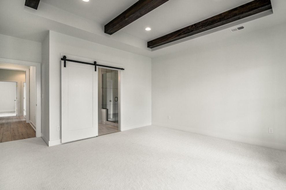 Photo of a modern master bedroom in Louisville with white walls, carpet, white floor and exposed beam.