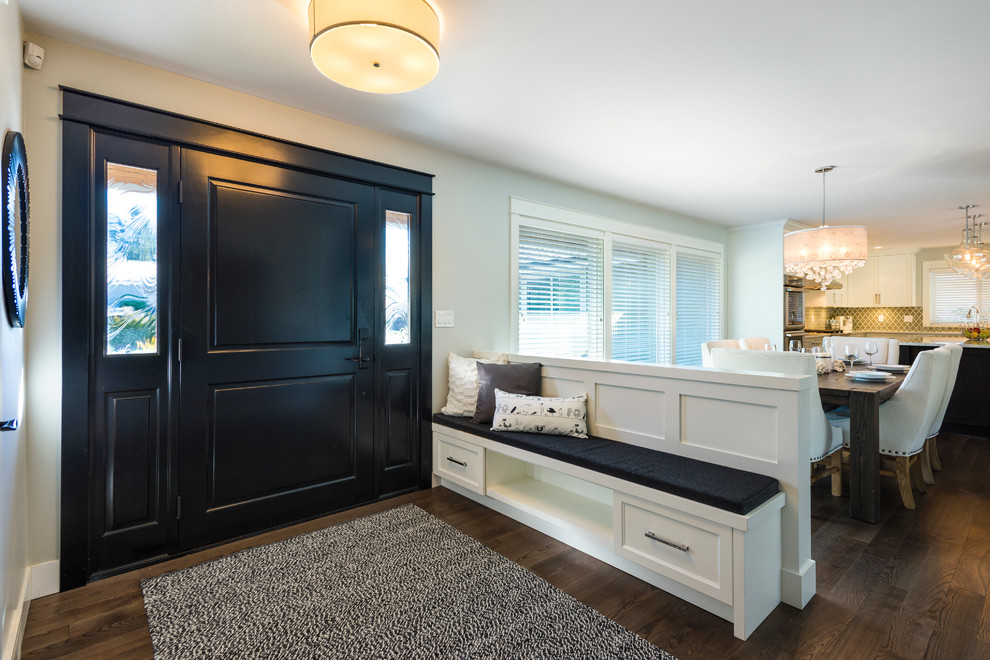 Foyer - mid-sized transitional medium tone wood floor foyer idea in Vancouver with gray walls and a black front door