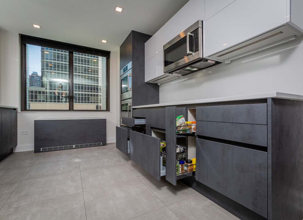 Small modern galley eat-in kitchen in New York with an undermount sink, flat-panel cabinets, grey cabinets, quartz benchtops, white splashback, engineered quartz splashback, panelled appliances, painted wood floors, with island, grey floor and white benchtop.